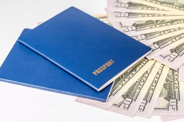 Two passport and money, American dollars banknotes bills on white background