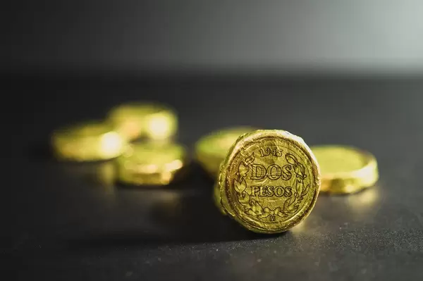Two pesos chocolate coin on a black surface