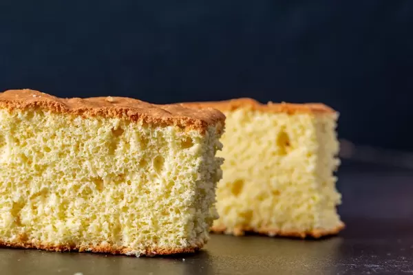 Two pieces of biscuit on a black background