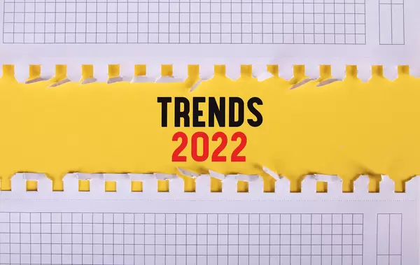 Two pieces of paper with Trends 2022 text on yellow