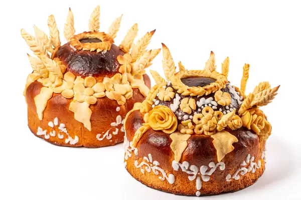 Two pies with leaves and flowers on white