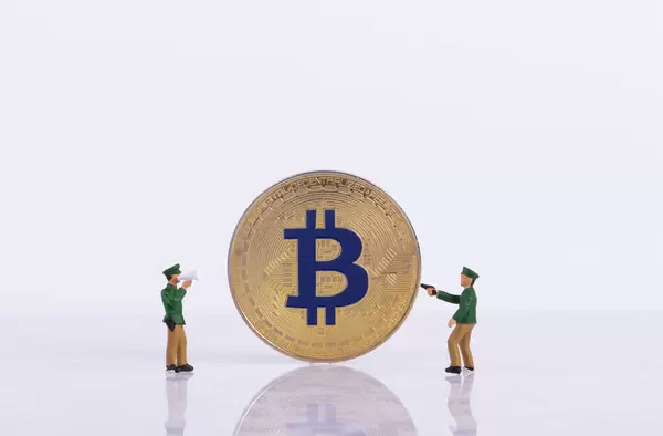 Two policeman with golden Bitcoin on white background