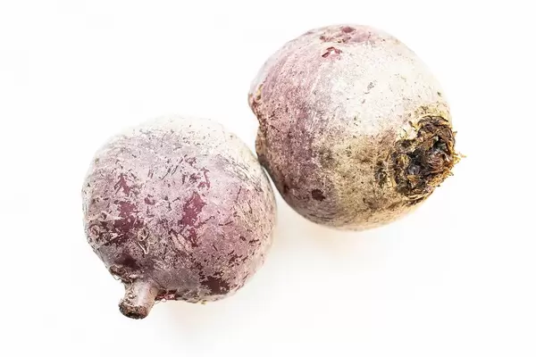 Two raw beetroots on white background  Flip 2019