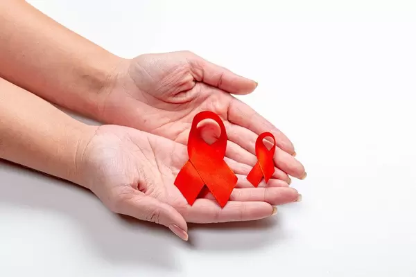 Two red ribbons in the hands of a woman on a white background (Flip 2019)