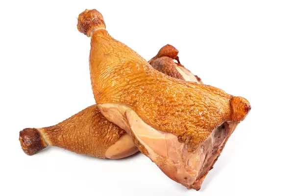 Two smoked chicken quarters on a white background