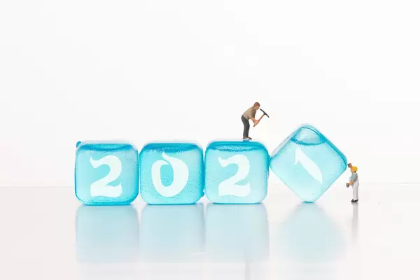 Two workers and blue ice cubes with 2021 text