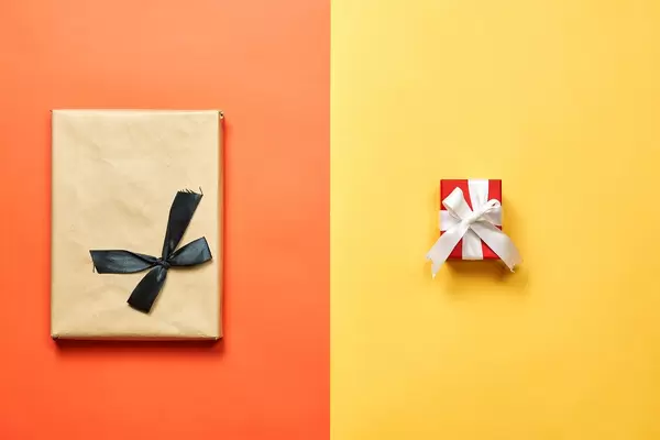 Two X-mas gifts on bright divided background