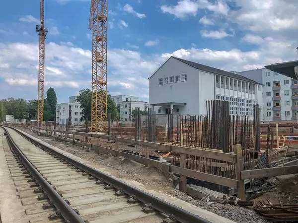 Two yellow cranes on the construction site of retirement home "Clarenbachstift", next to the railway in Cologne, Germany