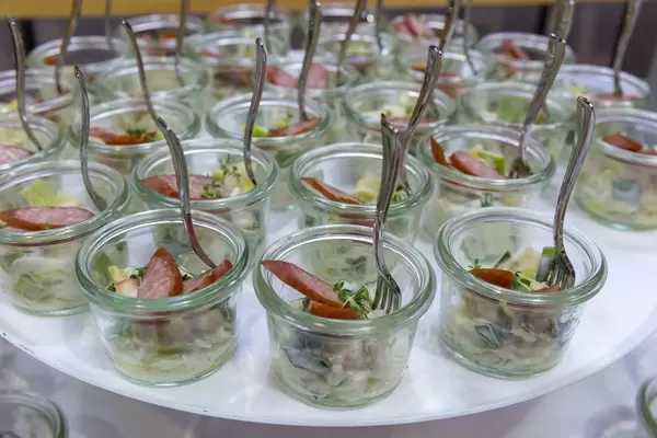Tyrolean smoked sausage on apple and leek salad in small jars at the BarCamp in Bonn