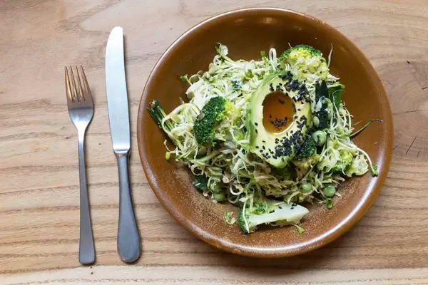 ULTRA GREEN BOWL with shaved brussels sprouts, broccoli, fresh peas, scallions, zucchini, avocado, sesame & pumpkin seeds, sesame oil