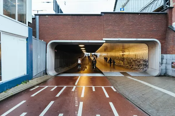 Underpass under the main train station in Amsterdam with 2 bike lanes and a sidewalk