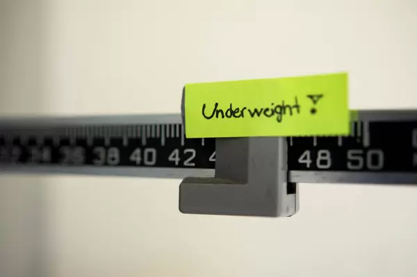 UNDERWEIGHT note on 42 pounds in a scale
