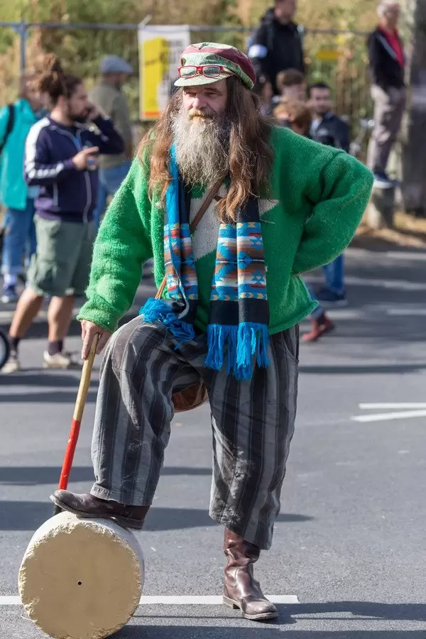 United for climate: old Hippie with walking stick supports protest march and strikes to end the climate crisis