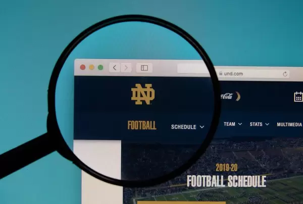University of North Dakota website on a computer screen with a magnifying glass