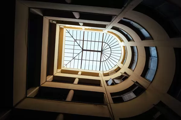 Upward perspective of U-shaped skylight inside the inner garden in Athens, Greece
