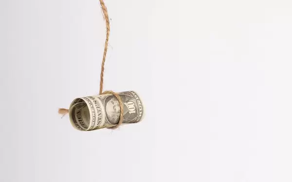 US dollar held by a rope