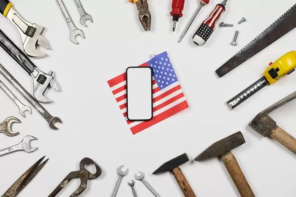 USA Labor day background with many working tools and smartphone on white