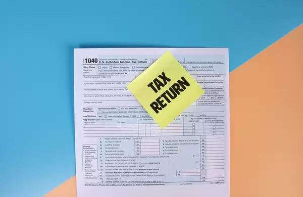 USA tax form 1040 for US individual tax return and sticky note with Tax Return text