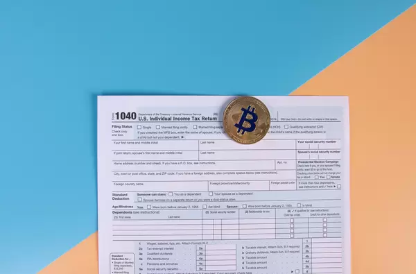 USA tax form 1040 for US individual tax return with golden Bitcoin coin