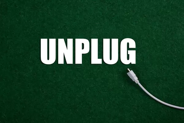 USB cable and Unplug text on green grass