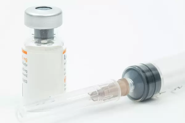 Vaccine bottle with injection needle