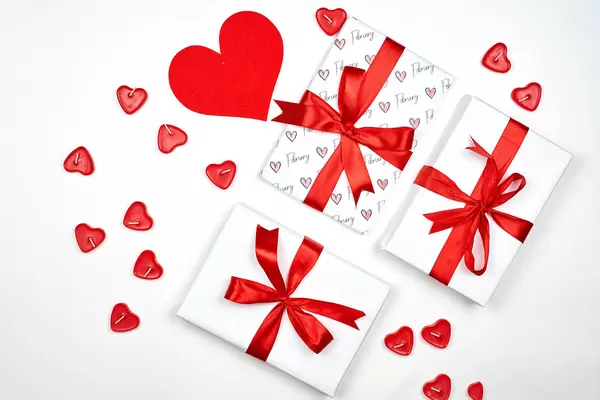 Valentine Day background with gift boxes and hearts on white