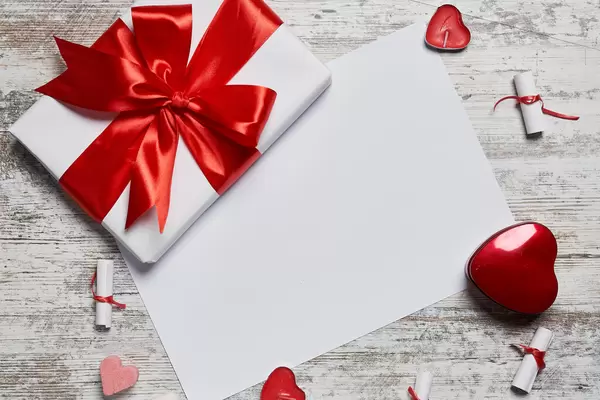 Valentine's day background with gift box and white paper with copy space