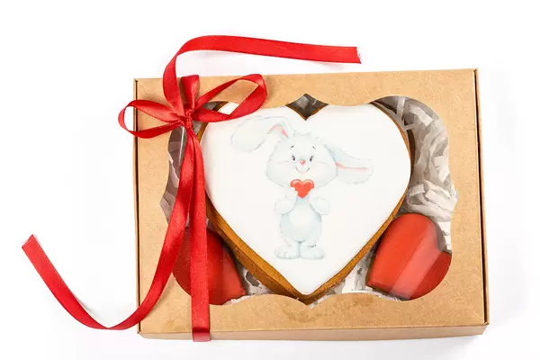 Valentine's day cookies in gift box on white background, top view