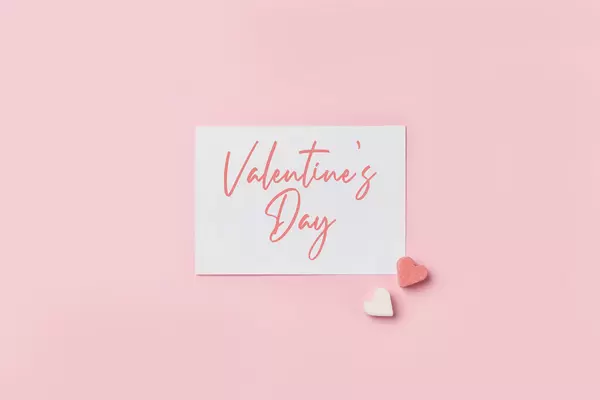 Valentine's day text on paper card with heart shape sugar forms