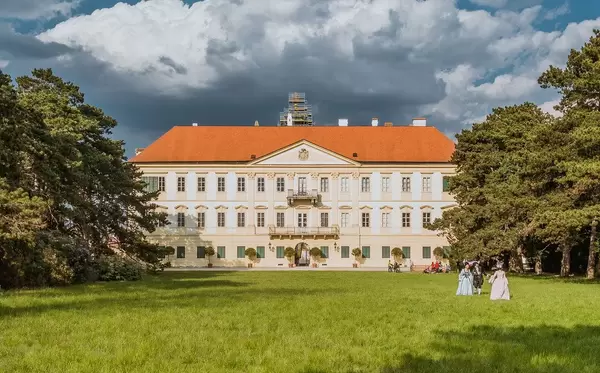 Valtice castle with trees and cloudy sky