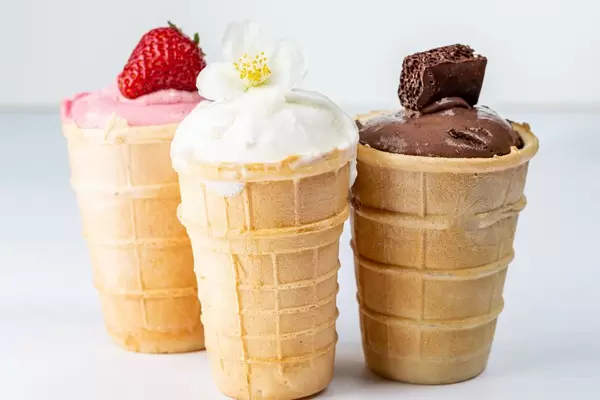Vanilla, chocolate and strawberry ice cream in waffle cups