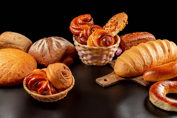 Variety of bakery products on dark background