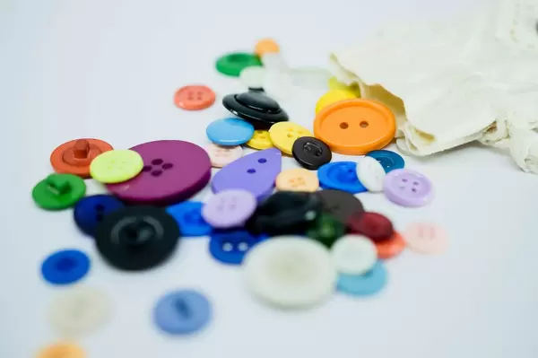 Variety of buttons coming out of a pouch