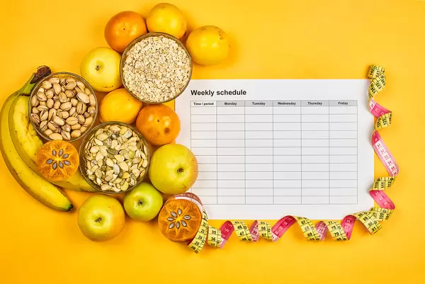 Variety of vegetables, fruits and seeds on yellow. New healthy lifestyle