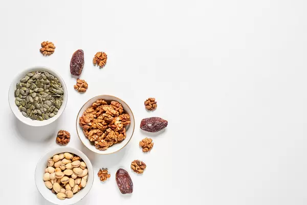 Various nuts and dried fruits on white background