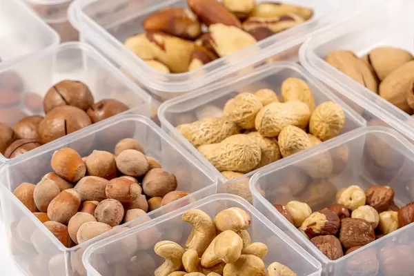 Various nuts in plastic boxes, close-up