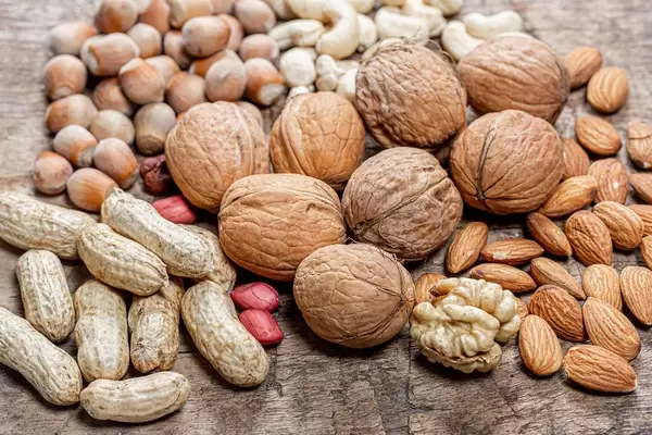 Various nuts on an old wooden background