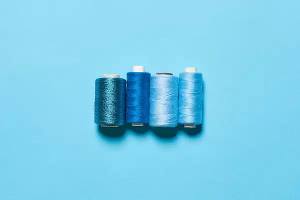 Various shades of blue thread spools