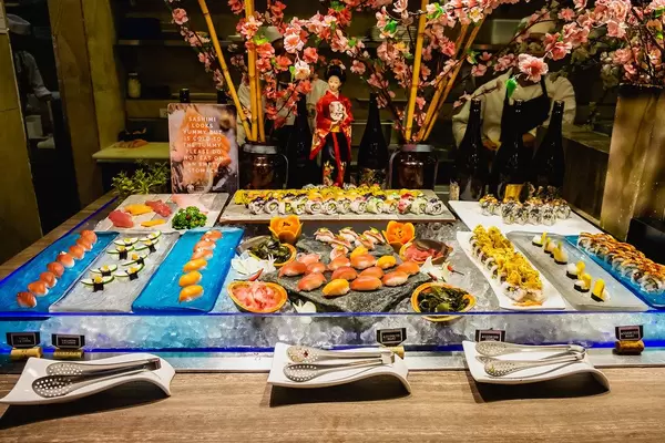 Various types of sushi on display at a buffet restaurant