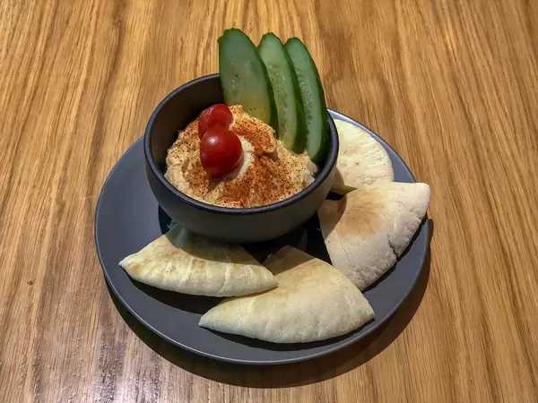 Veg hummus at Avocado Cafe: chickpeas, sesame paste, lemon juice, garlic, olive oil, spices, cucumbers, tomatoes, pita bread