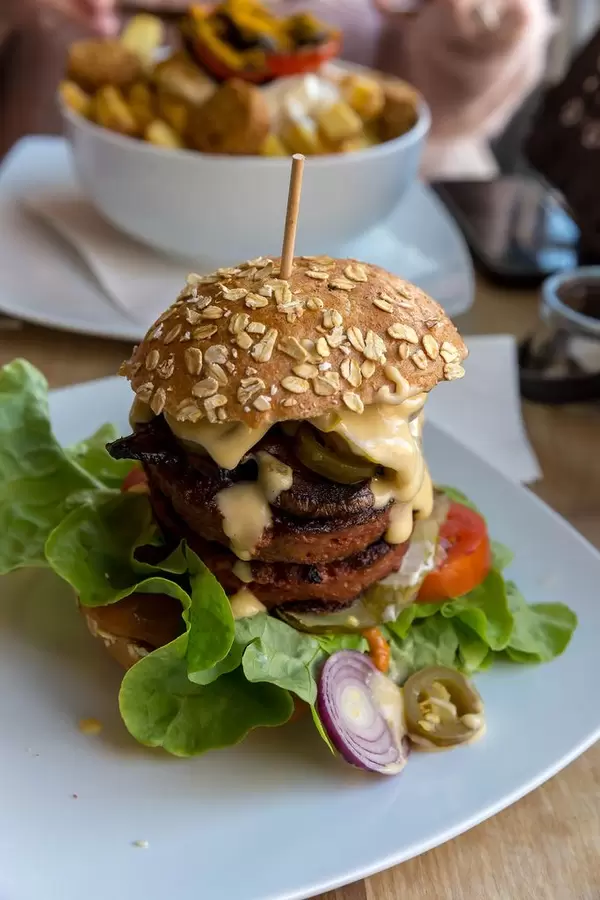 Vegan Beyond Meat Burger with fresh vegetables and Portobello mushroom bacon