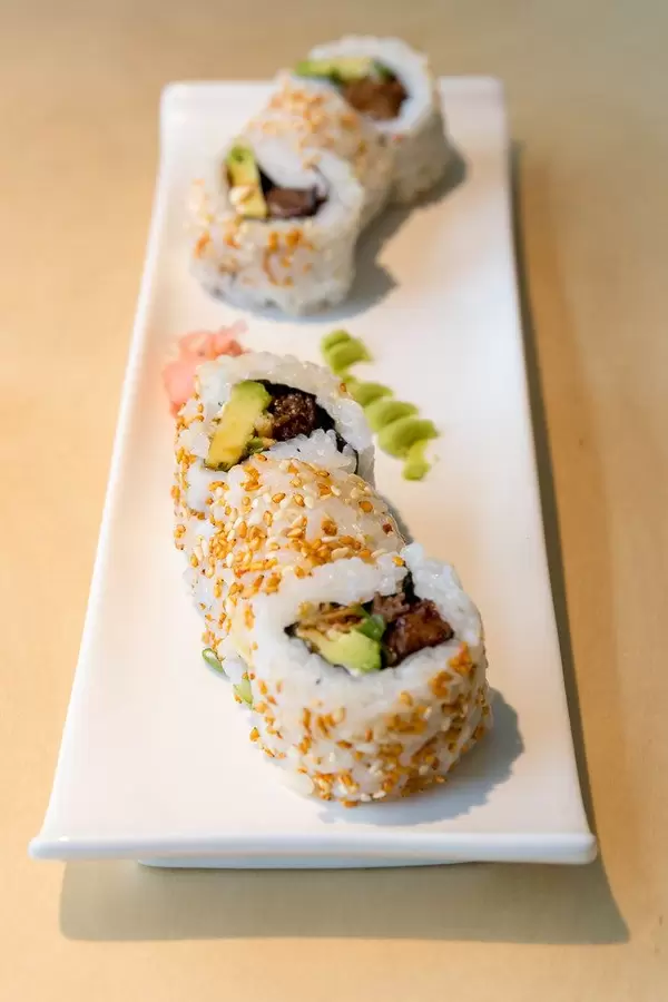 Vegan sushi plate and meatless lunch "Lucky No Meat" with baked tofu, vegan mayo substitute, sweet sauce, kimchi sesame seeds and fried onions