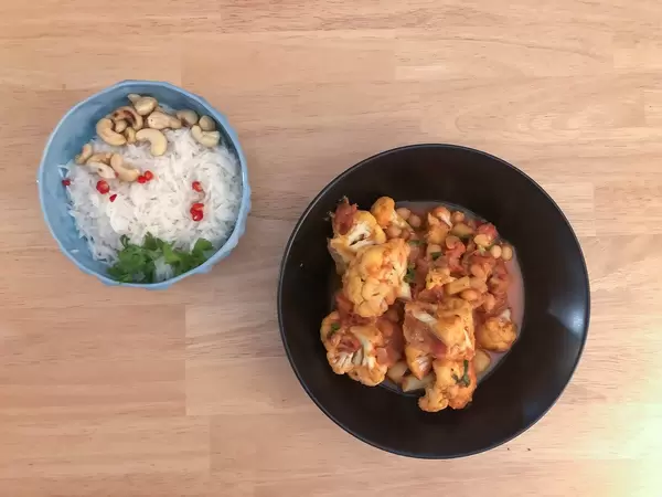 Veganer Blumenkohl-Curry und Reis mit Chili und Cashewnuss