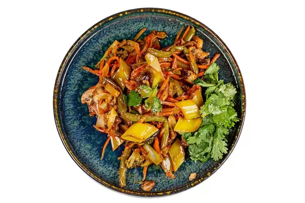 Vegetable salad with mushrooms in sweet and sour sauce, top view