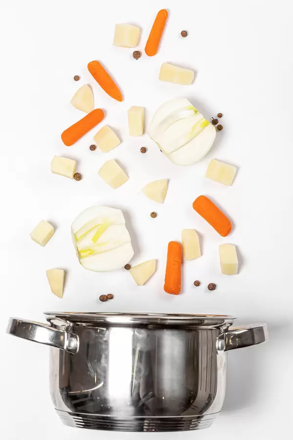 Vegetable soup cooking concept, saucepan with ingredients