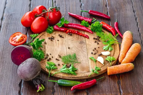 Vegetables and spices on a brown wooden background