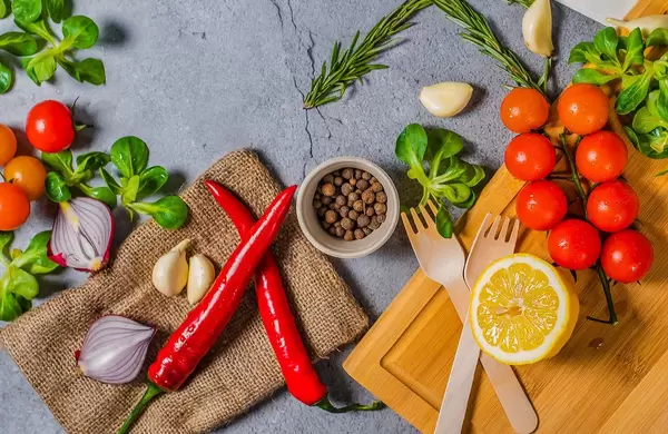 Vegetables, chilli, onions, tomatoes on background