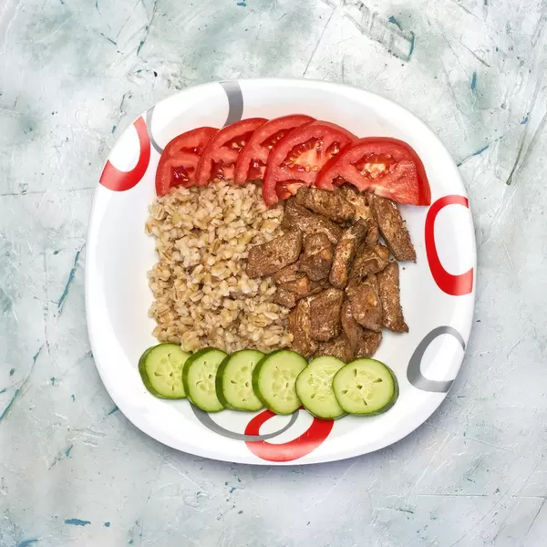 Vegetarian lunch bowl with chicken fillet, pearl barley and vegetables