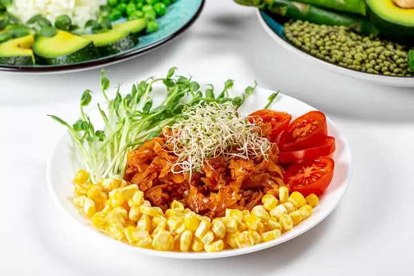 Vegetarian lunch with stewed cabbage, vegetables and micro greenery (Flip 2020)