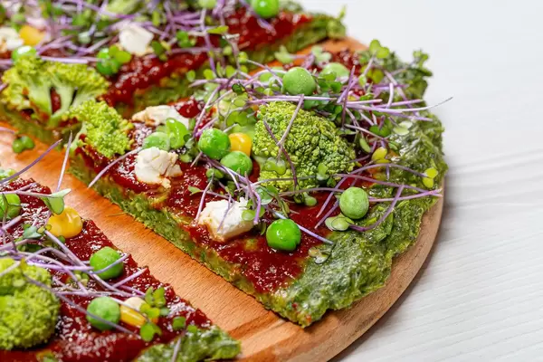 Vegetarian pizza with micro-green cabbage, tomato sauce, broccoli, corn, peas and feta cheese (Flip 2019)